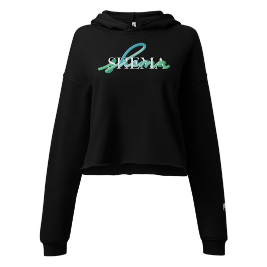 A black cropped hoodie sweatshirt with a 'SHEMA' graphic printed across the chest in teal and white, shown against a plain white background.